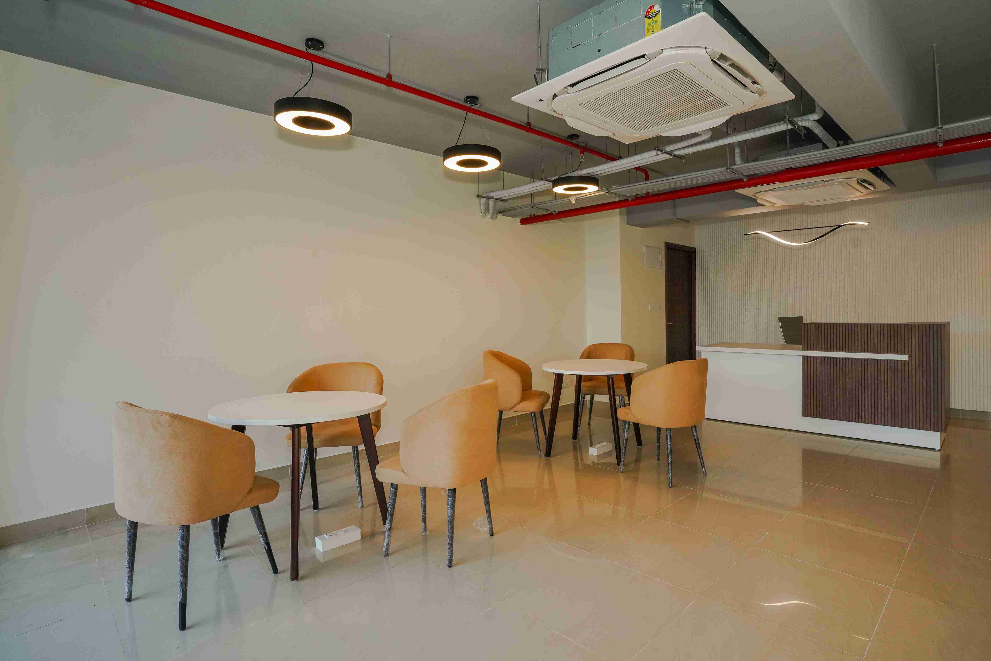 Air-conditioned common area with tables and seating