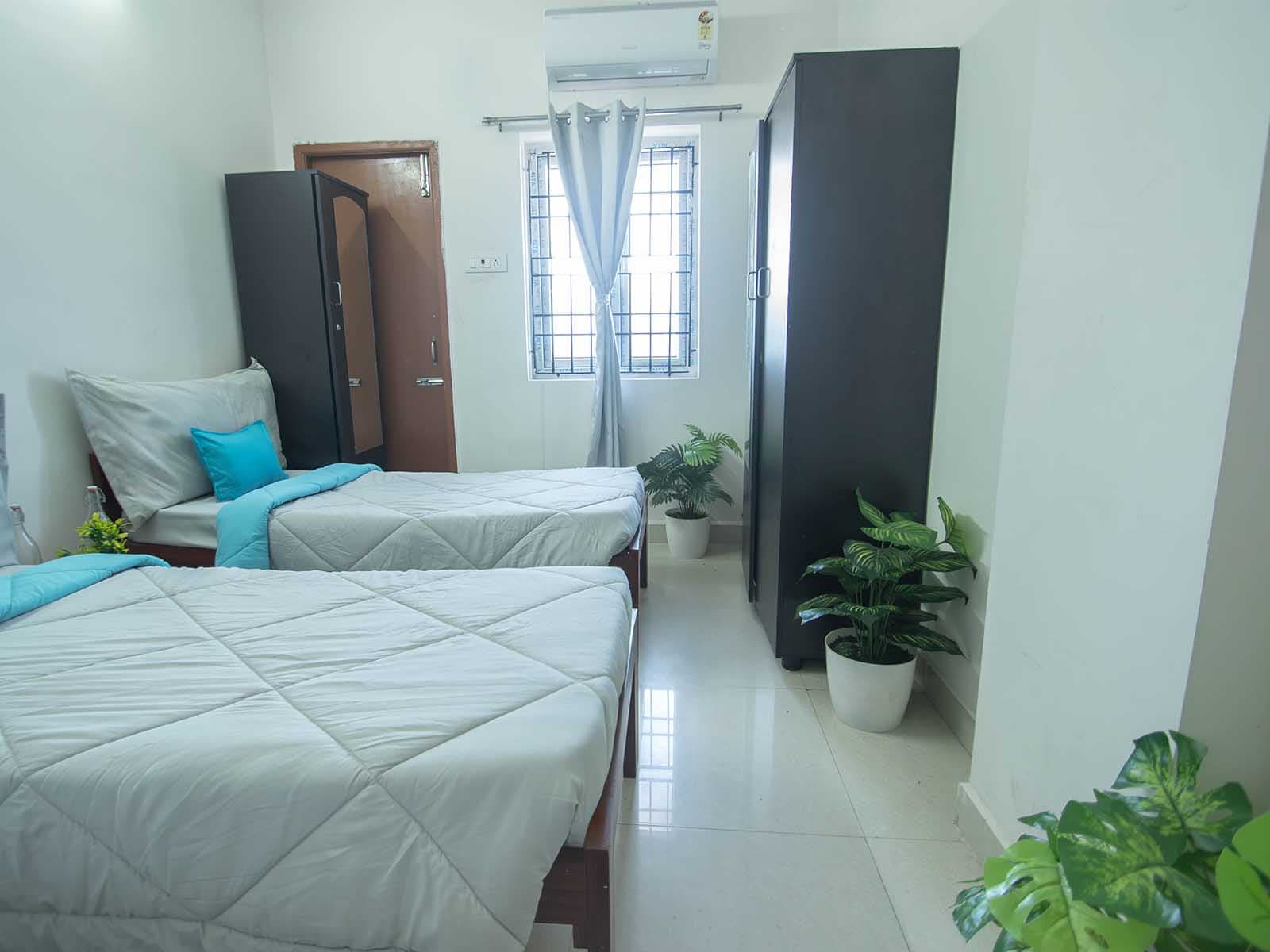 Air-conditioned twin-sharing room with wardrobes at Zolo Dreamtown